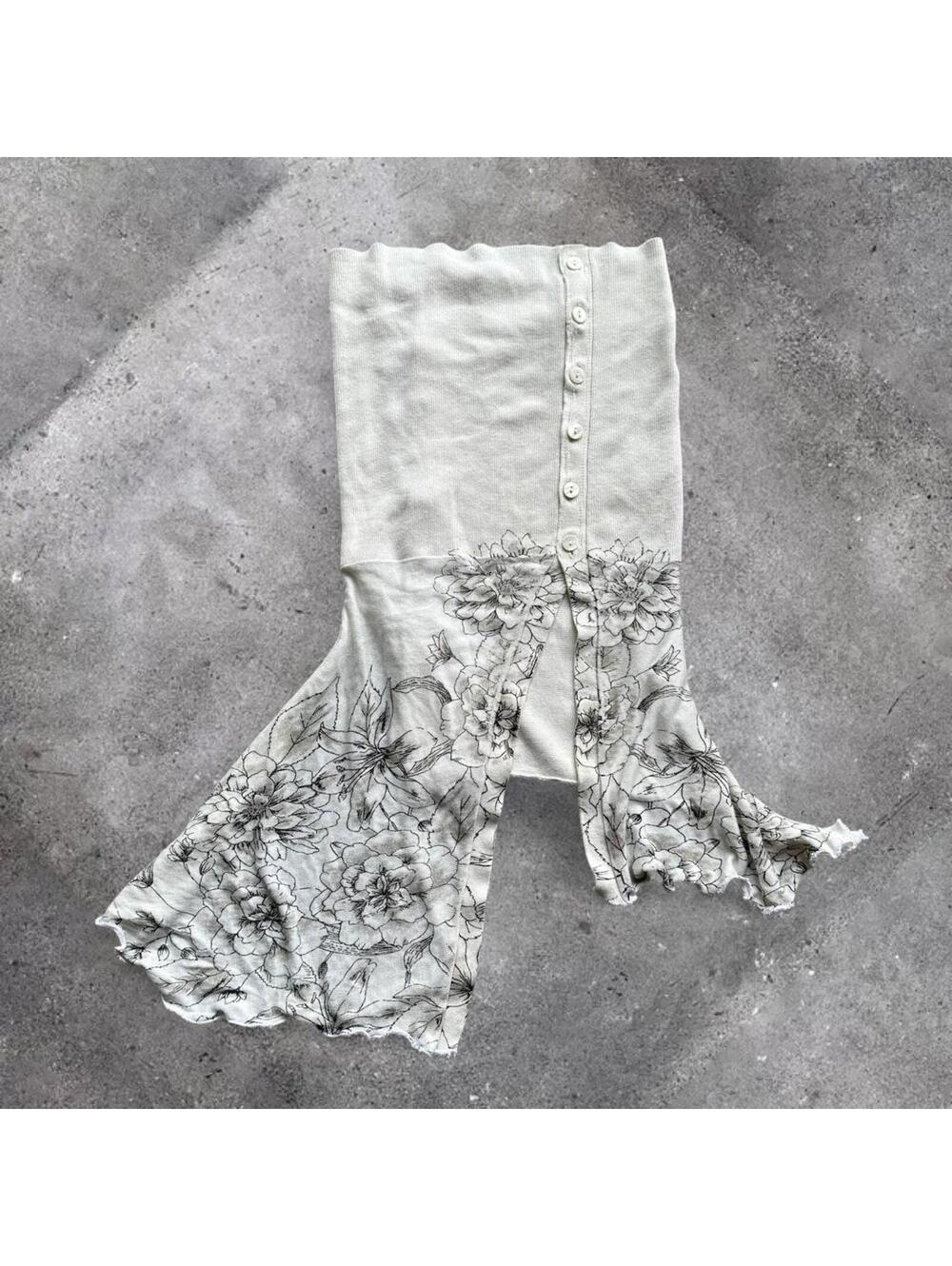 asymmetrical white knit tube top with button details and corset lacing